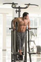 Fototapeta na wymiar Chest And Triceps Exercise on Parallel Bars