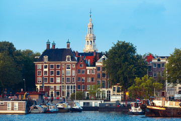 Amsterdam canal with typical dutch houses and church Zuiderkerk, Holland, Netherlands.