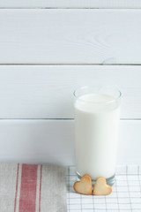 Cookies in the form of hearts with milk.