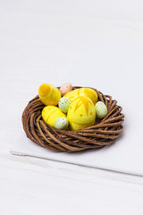 Easter eggs in the nest on white background
