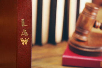 Law book with judge gavel on background