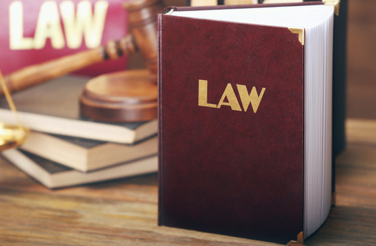 Law book on wooden background