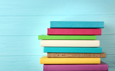 Colorful notebooks on wooden background