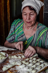 Grandma preparing dough dumplings and