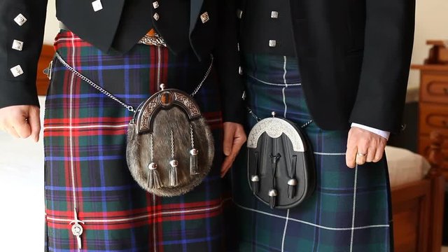 Closeup of two Scottish kilt during a wedding ceremony.
