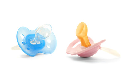 Baby pacifiers on white background