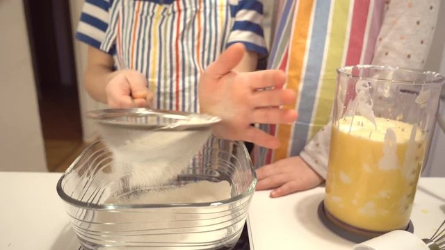 Two happy children playing and having fun during baking Easter sweets