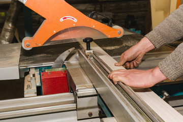 Men at work sawing wood. Circular saw.