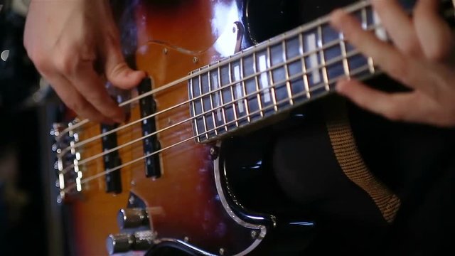 close up shot of bass playing rock n roll.