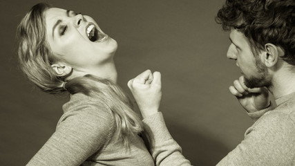 Aggressive man yelling on woman.