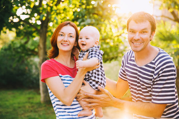 Happy family having fun and laughing on nature