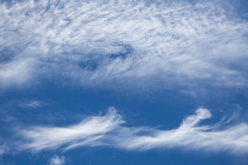 Wispy cirrus clouds blue sky
