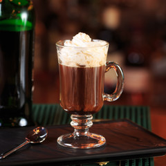 Irish coffee in a bar. Concept of St Patrick holiday. Holiday ba