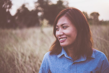 Portrait of young beautiful smile woman in sunset. Vintage filte