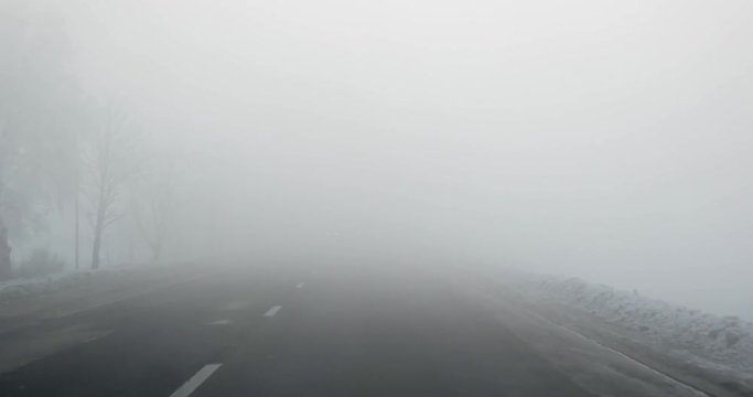 Driving Car Point of View on Winter Morning Foggy Road With Sun at the Sky Car Front Window Windscreen View in Early Morning Foggy Sunrise Wanderlust