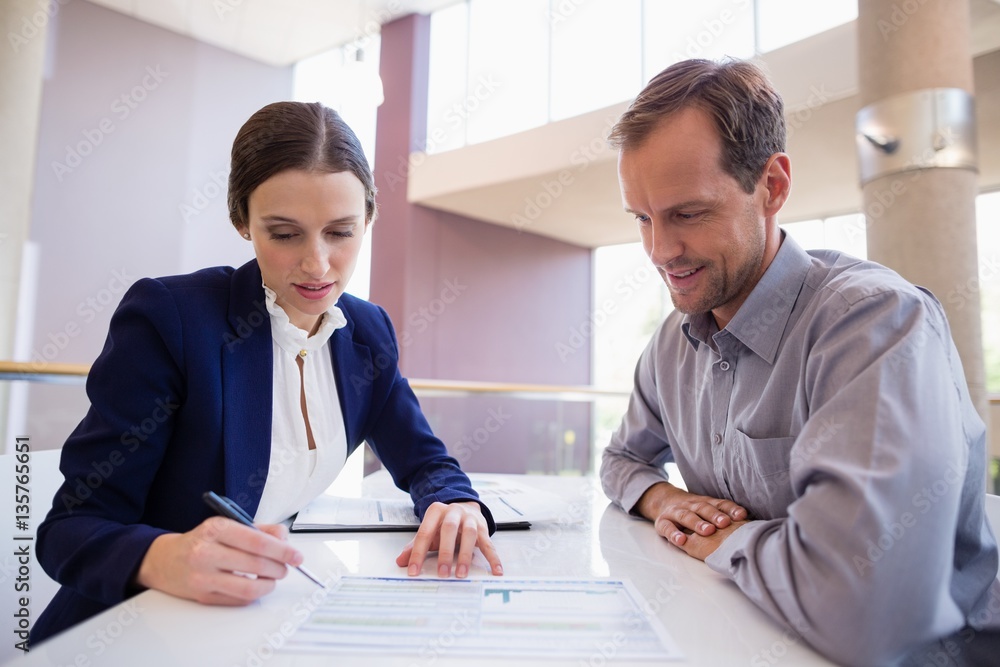 Wall mural Business executives discussing over document