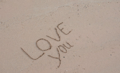 writing love on sand  