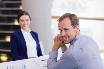 Business executives sitting at desk 