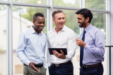 Fototapeta premium Business executives discussing over digital tablet