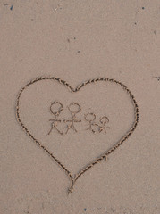 Heart drawn in sea beach sand, family concept