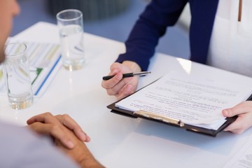 Business executives discussing over document