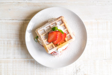 waffle with strawberry on wood