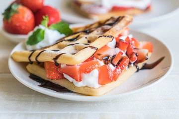 waffle with strawberry on wood