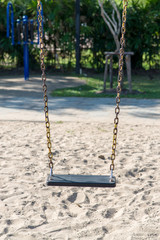 Swings and colorful playground in park