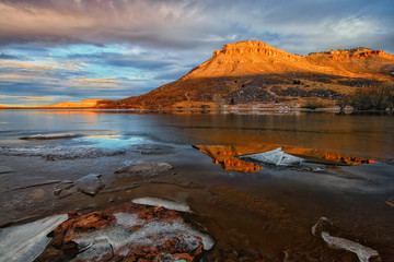 Sunlight on the Red Butte with  lake in the foreground