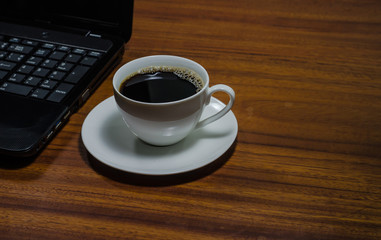 Black coffee on the wooden table