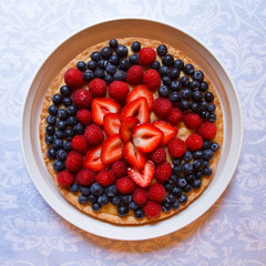 Plate of strawberries, blueberries and raspberries in the shape of a star