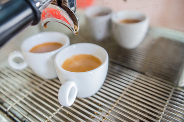 Barista making a cup of coffee soft focus image .