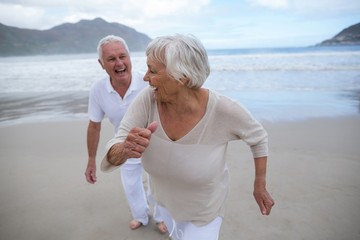 Senior couple having fun together at beach