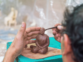 Artist making detail of resin female figure