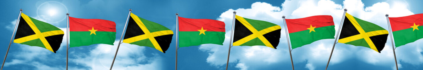 Jamaica flag with Burkina Faso flag, 3D rendering