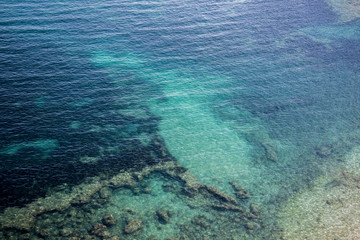 Turquoise sea with rocky bottom