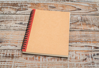 Blank notebook mock up on wood background .