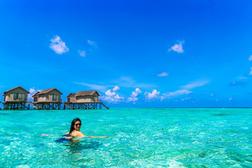 Portrait of happy young woman at beautiful water villa at Maldiv