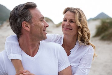 Mature couple standing together on the beach