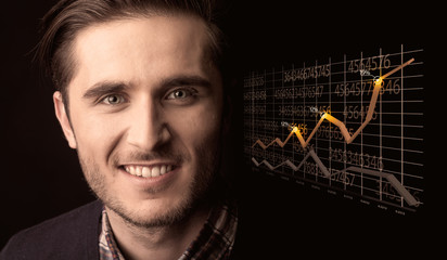 Happy businessman with a growing graph