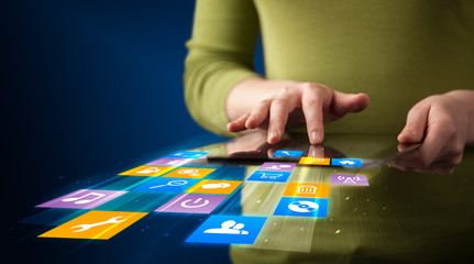 Hand holding tablet device with media application