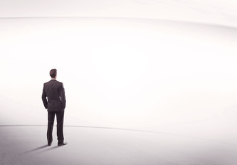 Fototapeta premium Businessman with briefcase standing still