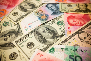 Chinese Yuan Note and U.S. dollar background  (Exchange rate concept)