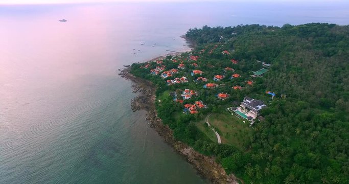 Aerial footage. Flying close over tropical sandy beach and waves. Luxury resort. Thailand. Phuket. Layan beach. 4K