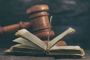 Law gavel on old brown leather book 