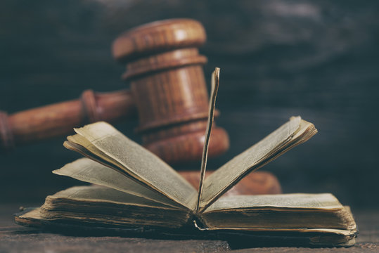 Law gavel on old brown leather book 