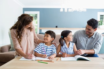 Parents assisting their kids in doing homework