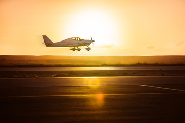 small plane on the runway - Powered by Adobe