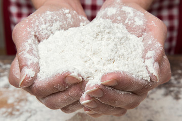 Flour in the hands in the kitchen. Healthy eating and lifestyle.