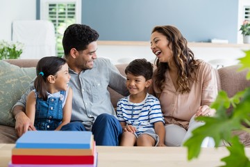 Parents and kids interacting on sofa in living room